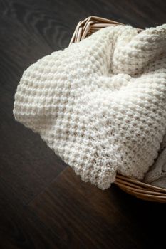 Knitted winter clothes in a basket