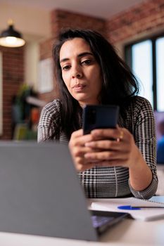 Student employee browsing internet on smartphone