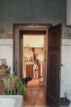 black ivorian african young fit woman cooking at home in small kitchen in summertime