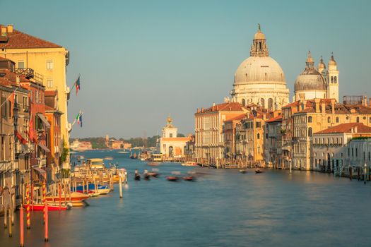 Blurred Gondole in grand canal at golden sunrise, Ethereal Venice, Italy