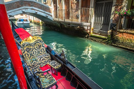 Ornate Gondola in peaceful Canal corner at sunny day, Venice, Italy