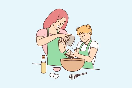 Happy mother and daughter cooking together