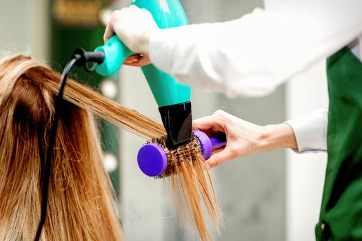 Young woman receiving drying hair