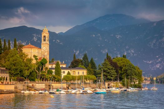 Lake Como coastline with Tremezzo village and sailboats at sunny day, Italy