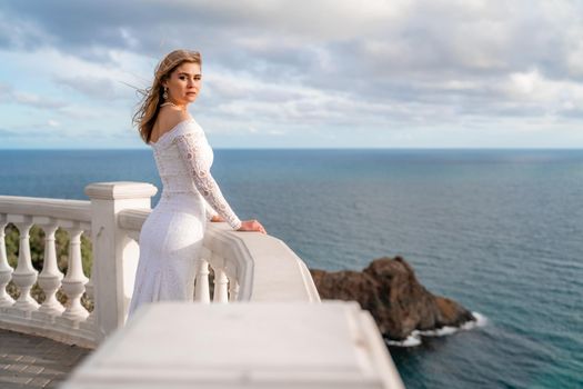 Bride walking along sea coast wearing beautiful wedding dress