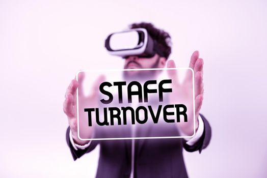 Text caption presenting Staff TurnoverThe percentage of workers that replaced by new employees. Concept meaning The percentage of workers that replaced by new employees Man With A Pen Pointing On Power Button Symbol Containing Data.