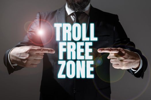 Sign displaying Troll Free Zone. Business overview Social network where tolerance and good behavior is a policy Man And Woman Presenting Important Informations On Presentation Board.