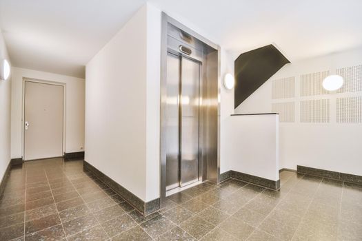 Modern elevator in apartment building hall