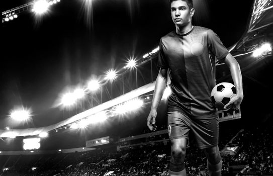 Black and white photo of teenager - soccer player. Man in football sportswear after game with ball. Sport concept.