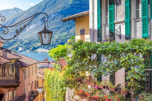 Colorful old town street with springtime balcony in Bellagio, Italy