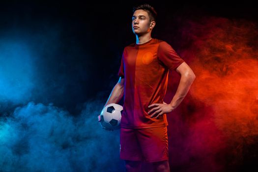 Teenager - soccer player. Man in football sportswear after game with ball. Sport concept.