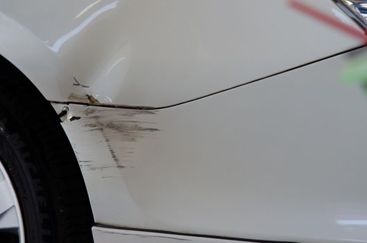 White car accident with abrasions. Concept car insurance business.