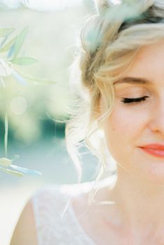 Half face of bride with closed eyes and high hairdo