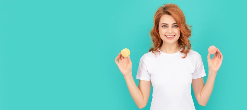 happy woman hold sweet macaron french cookie on blue background. Woman isolated face portrait, banner with mock up copyspace