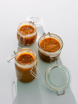Salted caramel in glass jars. Vertical