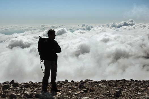 Male standing on the summit of a mountain peak