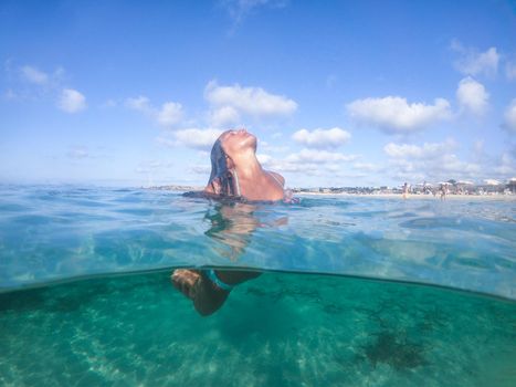 Woman diving into the sea.Formentera island, Spain.