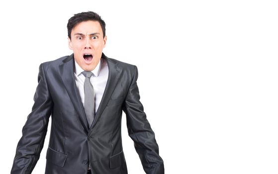 Panicked young man with opened mouth against white background