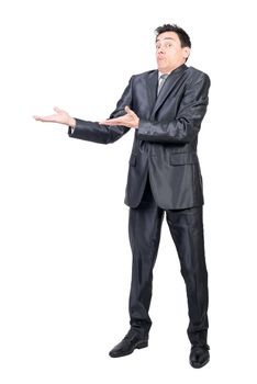 Astonished man in suit pointing aside. White background.