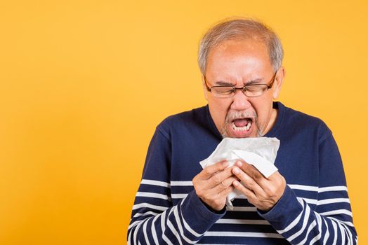 Asian elder man cold having flu and sneezing from sickness virus problem use tissue