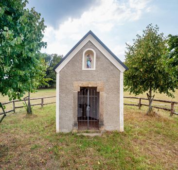 Renewal Marian Chapel in middle of pasture and cow farm. Historical monument in memory of a healed blind girl. Sluknov, Czechia
