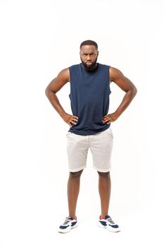 Young fitness african black man in sport wear cheering carefree isolated over white background.