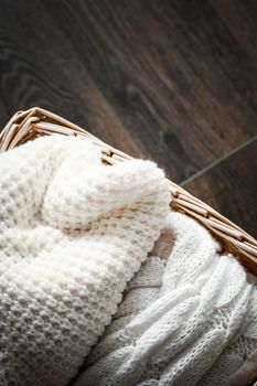 Knitted winter clothes in a basket