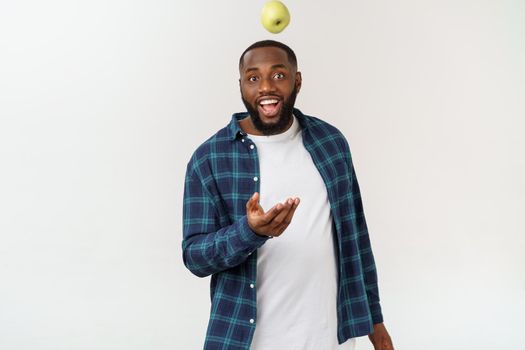 African man with green apple isolate over white background.