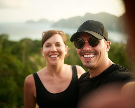 Capturing vacation vibes. Portrait of a happy young couple taking a selfie on an island vacation.