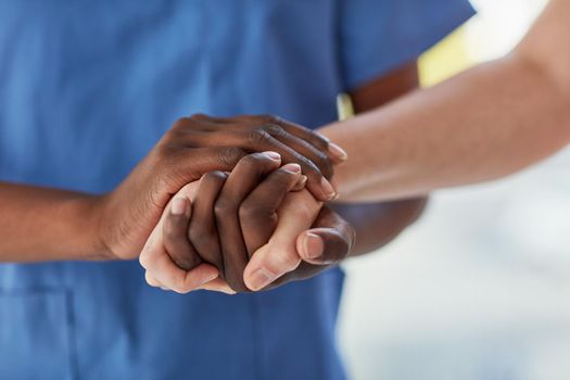 Offering a patient the care and comfort they need. Closeup shot of a medical practitioner holding a patients hand in comfort.