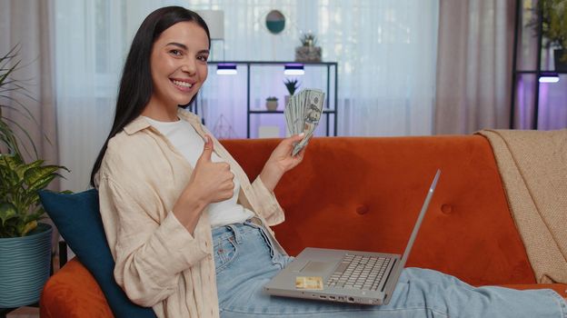 Young woman using credit bank card and laptop, transferring money, purchases online shopping