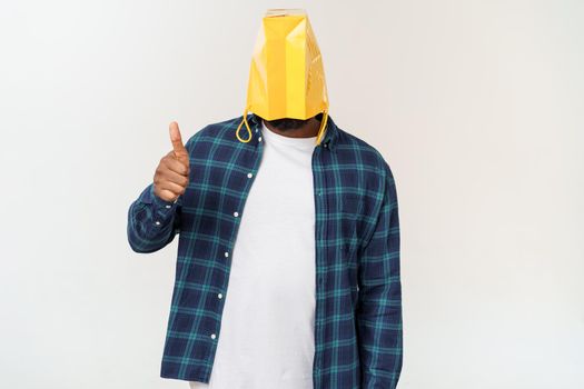 Man in paper bag on head showing with forefingers isolated on white background.