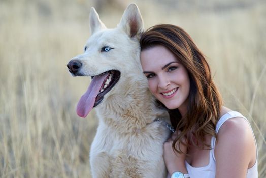 The best things in life are furry. Portrait of an attractive young woman bonding with her dog outdoors.