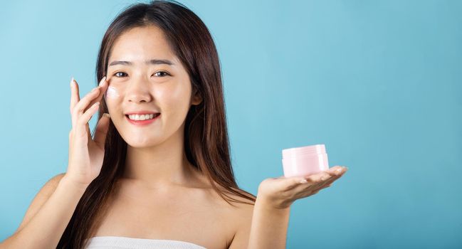 Asian young woman are not very beautiful hold jar of skin cream for face