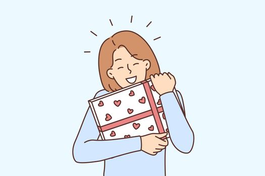 Happy woman holding present in hands
