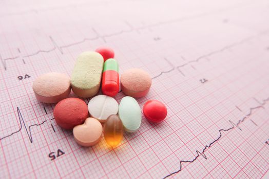 prescription medical pills on a cardio diagram.