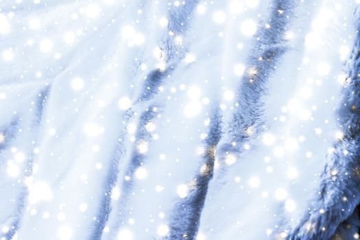 Holiday winter background, luxury fur coat texture detail and glowing snow