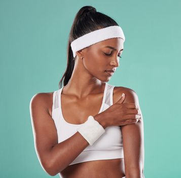 Sports injury, arm pain and tennis player suffering with sore muscles after a ball game at the court. Painful, hurt and discomfort woman after sport training or match against a studio background.