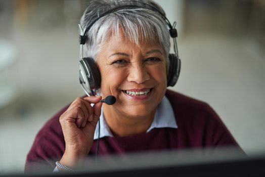 Helpful advice is just a call away. Portrait of a mature woman working in a call centre.