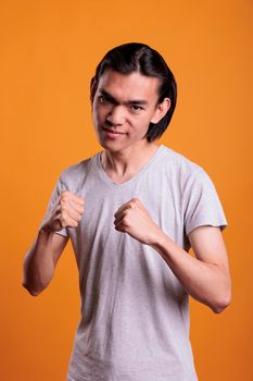 Angry asian man standing in fighting pose