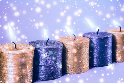 Christmas candles and shiny snow on blue background, holiday season decoration