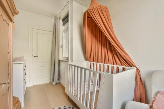Light cozy baby room with cot