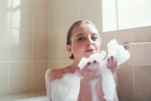 Relax and let go. Portrait of an attractive young woman relaxing in the bathtub.