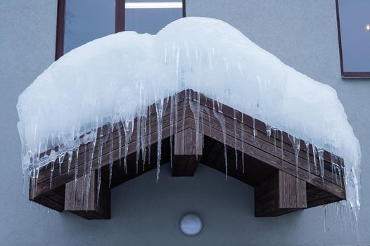 Roof with large icicles. Danger in the winter season.