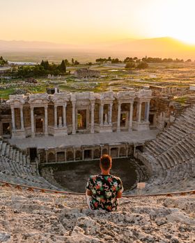 Hierapolis ancient city Pamukkale Turkey, young men watching sunset by the ruins Unesco
