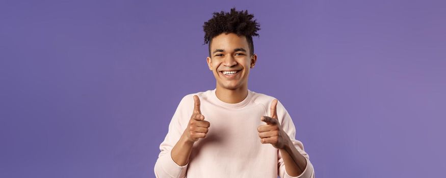 You got it. Close-up portrait of smiling cute young hispanic man saying good luck, pointing fingers at camera with pleased cute grin, encourage person apply for job, headhunter picking new candidates