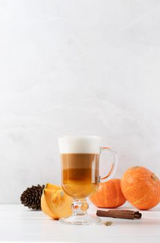 Pumpkin spice latte in a glass mug with cinnamon