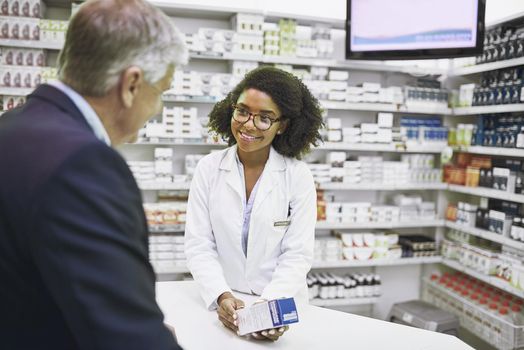 I found what you need. a cheerful young female pharmacist giving a customer prescription meds over the counter in a pharmacy.