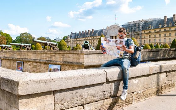 Young men with a tourist map in hand in the city of Paris France