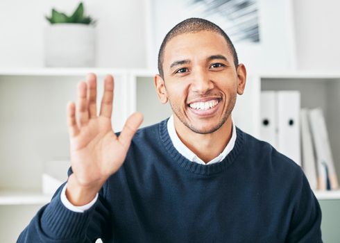 Waving, greeting and friendly employee with a bright smile and a positive mindset in the office. Portrait of a cheerful, joyful and excited Latino business man attending a videocall